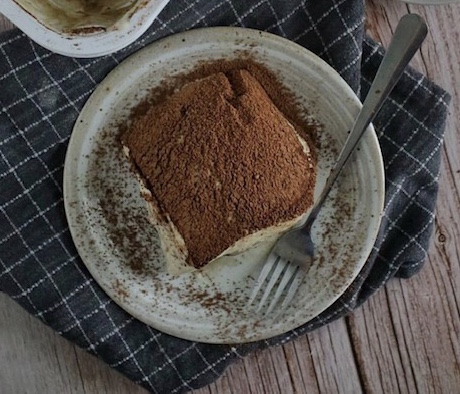 Top-down view of mascarpone cake slice with cocoa dusting